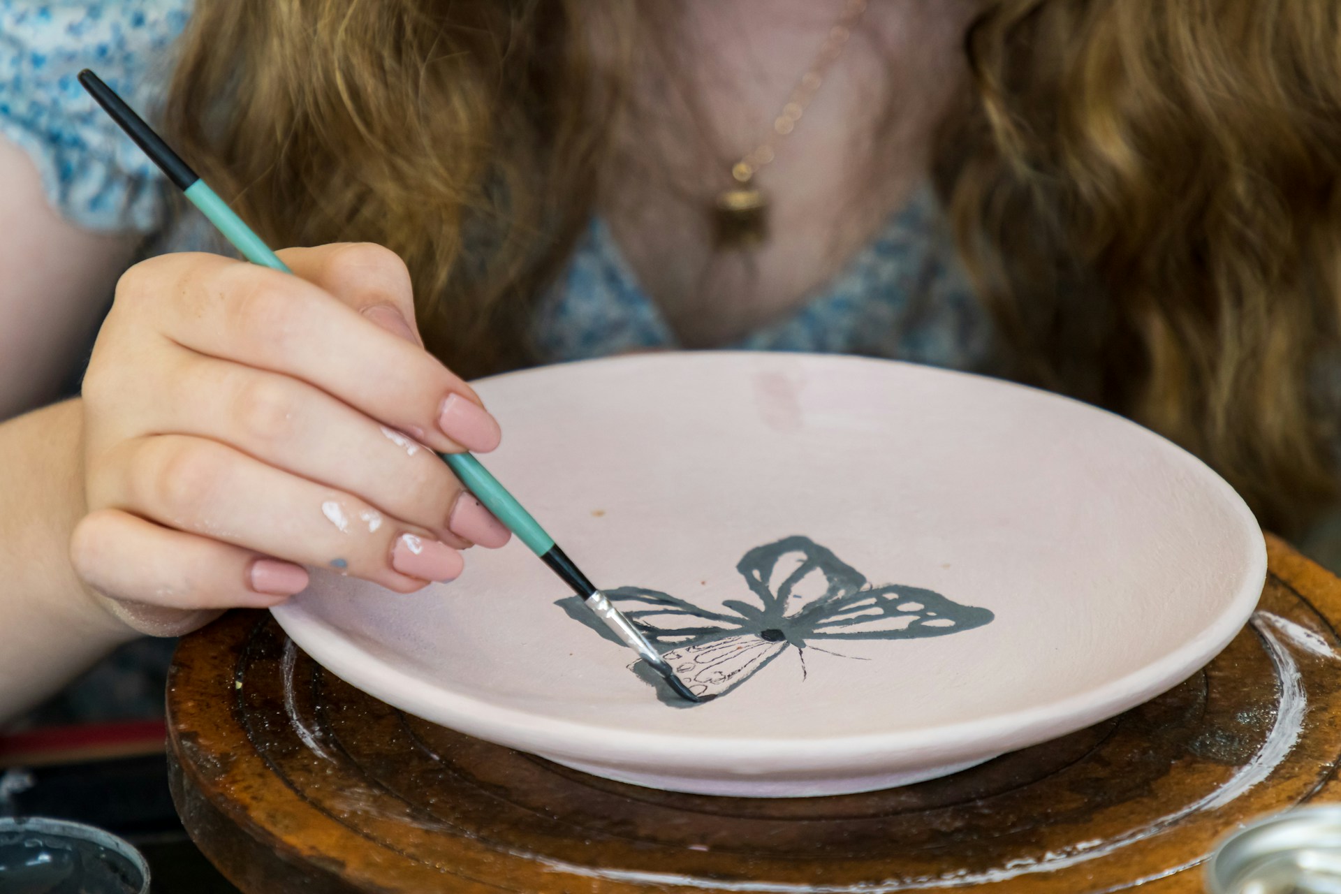 A hand-painted butterfly design on a ceramic plate